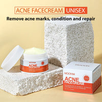Open jar of Kazven Clear Skin anti-acne cream next to its box, on pumice stone