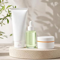 3-Step Clear Skin System: cleanser tube, serum dropper bottle, and cream jar together on a stone pedestal